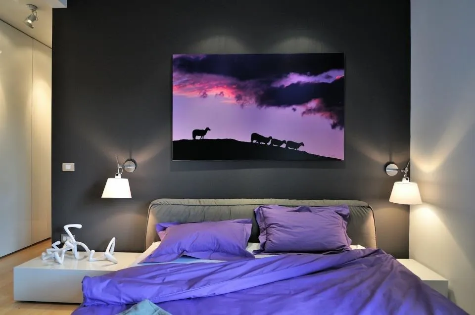 Small bedroom with a statement piece of wall art creating a focal point above the bed.